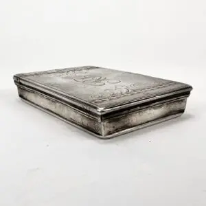 Silver rectangular box with engraved designs.