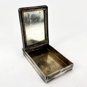 Open vintage metal box with mirror lid.