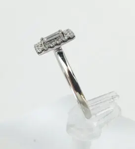Silver ring with rectangular diamond setting.