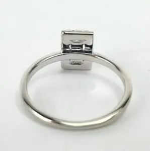 Silver ring with rectangular top view.