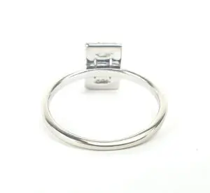 Silver ring with square setting on top.