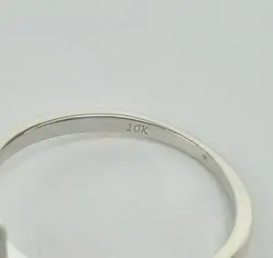 10K gold ring on white background.