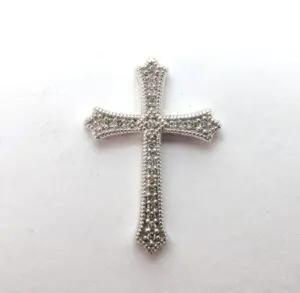 Silver ornate cross on white background.