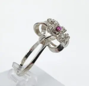 Silver ring with pink gemstone centerpiece.