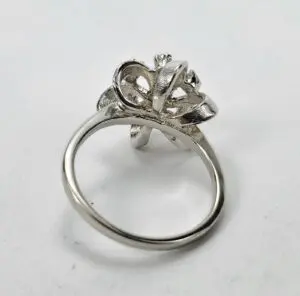 Silver ring with intricate floral design.
