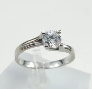 Silver ring with a round diamond solitaire.