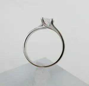 Silver engagement ring with single diamond setting.