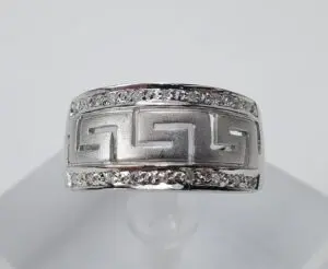Silver ring with geometric design and stones.