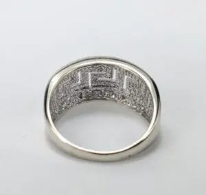 Silver ring with intricate geometric pattern design.