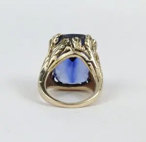Gold ring with blue gemstone center.