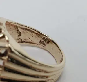 Gold ring with intricate inside engravings.