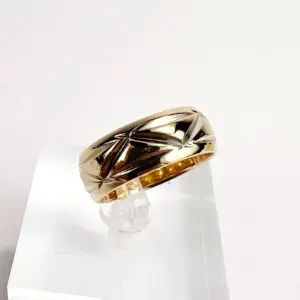 Gold ring with engraved star pattern.