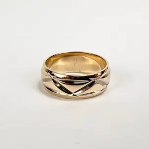 Gold ring with engraved geometric design.