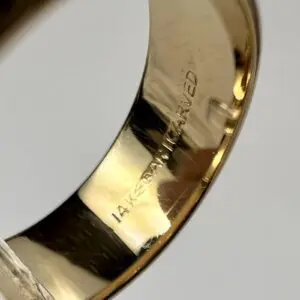 Close-up of 14K gold engraved ring.