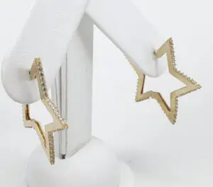 Star-shaped gold earrings with diamond accents.