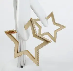 Gold star-shaped earrings with diamond accents.