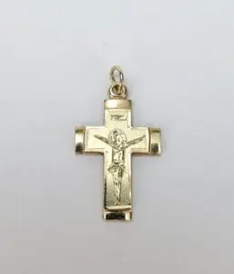 Gold crucifix pendant on white background.