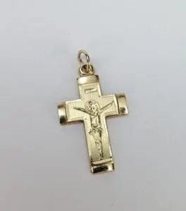 Gold crucifix pendant with Jesus figure.