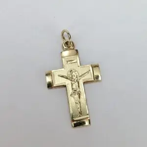 Gold crucifix pendant with Jesus figure.