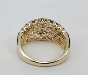 Gold ring with intricate lattice design underneath.