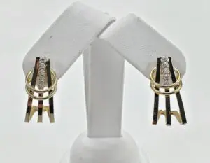 Gold and silver earrings with diamonds displayed.