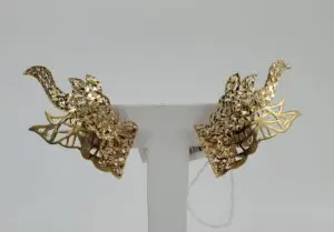 Intricate gold earrings with leaf design.