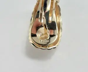 Gold earring back with "14K M" marking.