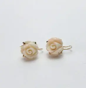 Carved floral earrings with gold hooks.
