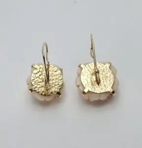 Gold and white round drop earrings.