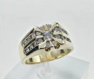 Gold ring with multiple diamonds on display.