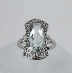 Silver ring with large rectangular gemstone.
