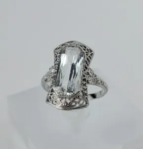 Silver ring with large rectangular gemstone.