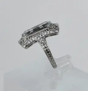 Ornate silver ring with rectangular gemstone.