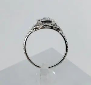 Silver ring with intricate detailing, side view.