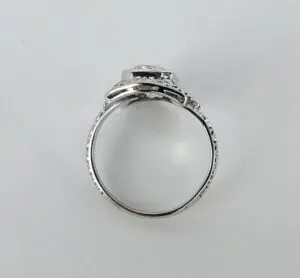 Silver ring with intricate detailing on band.