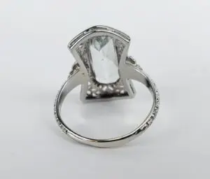 Silver ring with large clear gemstone.