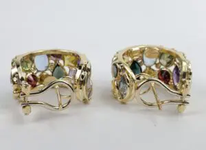 Gold earrings with colorful gemstones displayed.