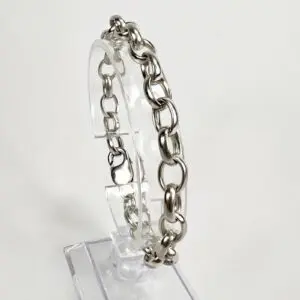 Silver chain bracelet on clear stand.