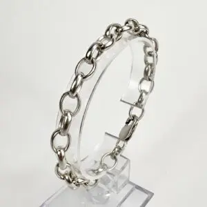 Silver chain bracelet on clear stand.
