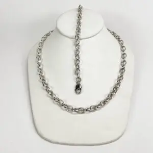 Silver chain necklace on white display bust.