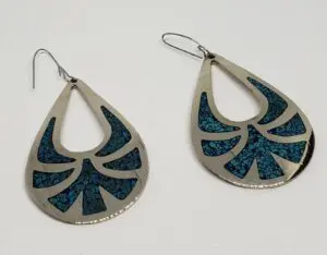 Silver teardrop earrings with blue patterns.
