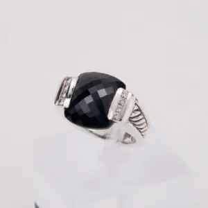 Silver ring with large black gemstone.