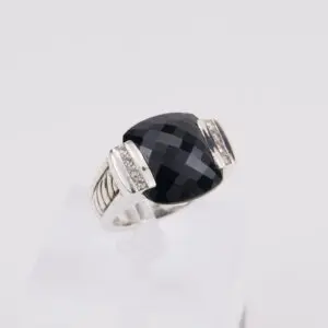Silver ring with large black gemstone.