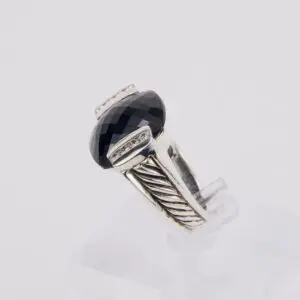Silver ring with large black gemstone.