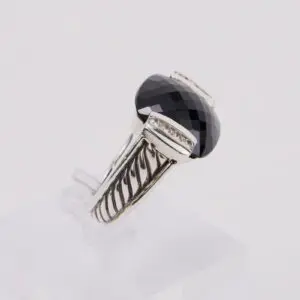 Silver ring with large black gemstone.