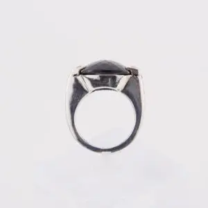 Silver ring with black gemstone, side view.