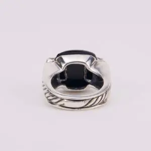 Silver ring with black gemstone, intricate design.
