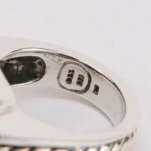 Silver ring with engraved markings inside band.