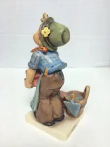 Figurine of a child with gardening tools.
