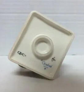 Bottom of a ceramic figurine with markings.